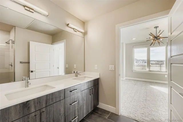 a bathroom with a double vanity sink and a mirror