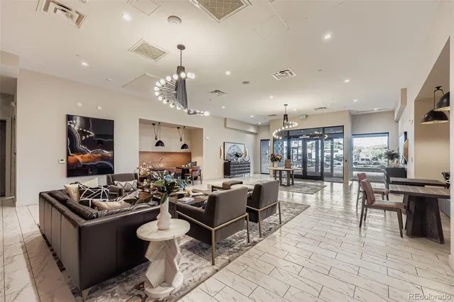 a living room with furniture a dining table and chairs