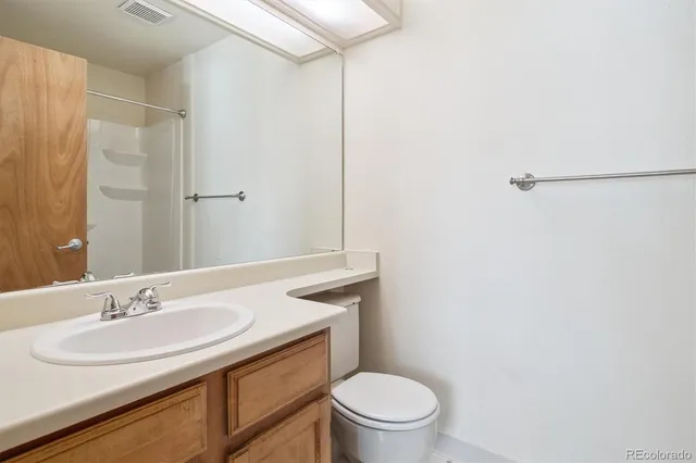a bathroom with a sink toilet and a mirror