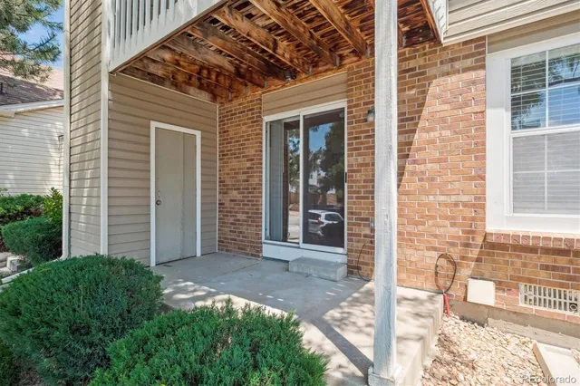 a view of a brick house with a large window