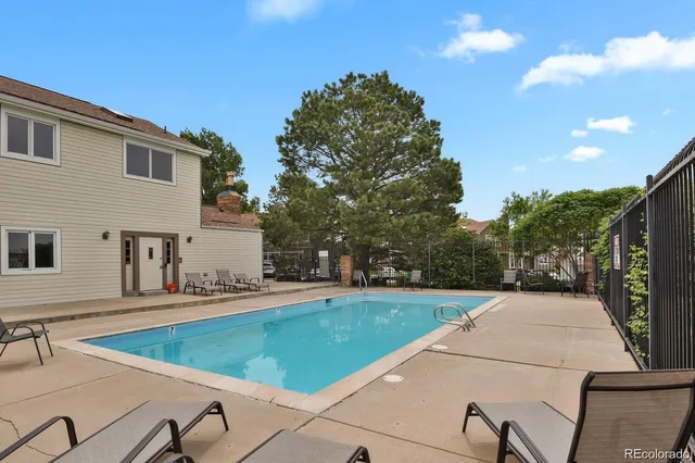 a view of a backyard with a white house