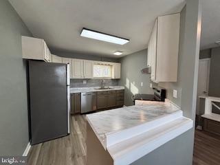 221 Hempt Road Mechanicsburg, PA 17050 - Photo 11 of 29 a kitchen with kitchen island a counter top space a sink stainless steel appliances and cabinets