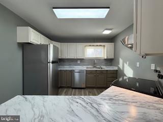 221 Hempt Road Mechanicsburg, PA 17050 - Photo 10 of 29 a kitchen with a refrigerator sink and cabinets
