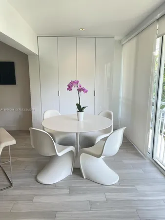 a dining room with furniture and wooden floor