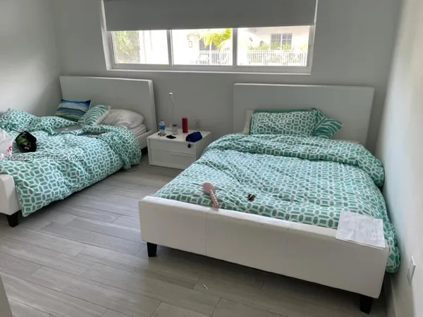 a bedroom with a bed and window