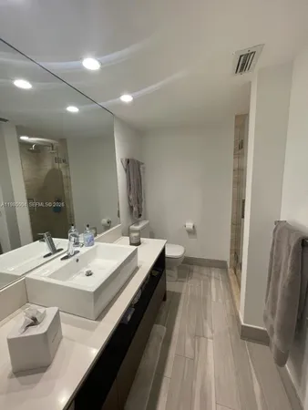 a spacious bathroom with a double vanity sink and a mirror