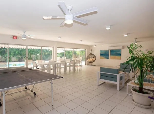 a room with lots of potted plants and a large window