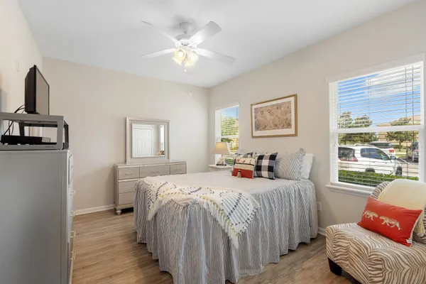 a bedroom with a bed and wooden floor