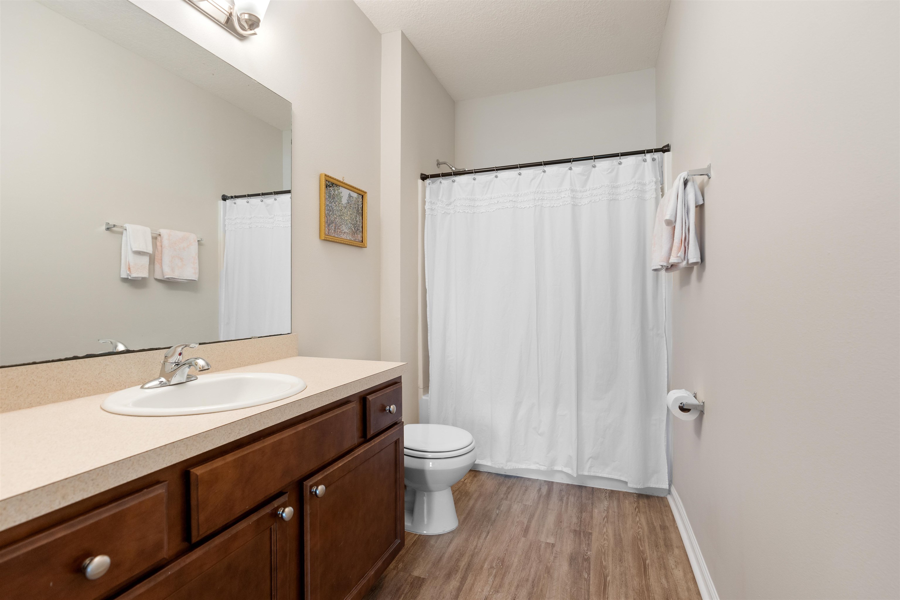 2251 Golden Lake Loop St. Augustine, FL 32084 - Photo 17 of 31 a bathroom with a sink a toilet a shower curtain and a large mirror