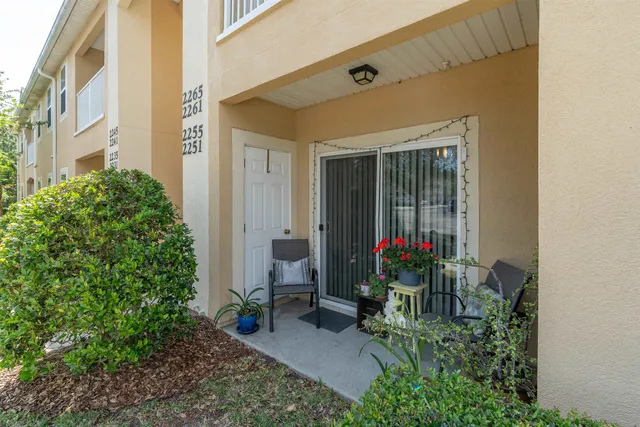 a view of a house with a porch and garden