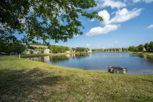 a view of a lake with houses in the back