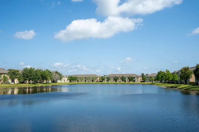 a view of a lake with houses in the back