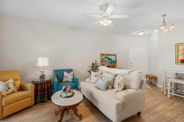 a living room with furniture a table and a fireplace