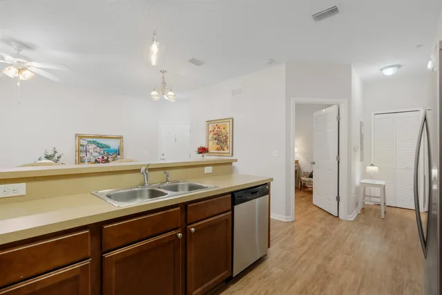 a kitchen with a sink and a refrigerator