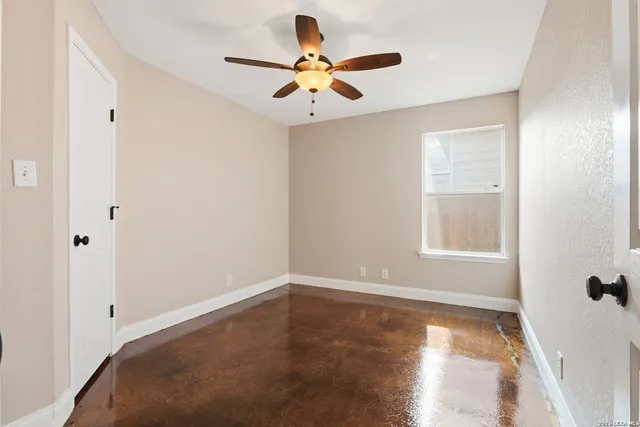 a view of room with window and ceiling fan