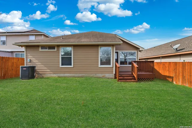 a front view of a house with a garden and yard