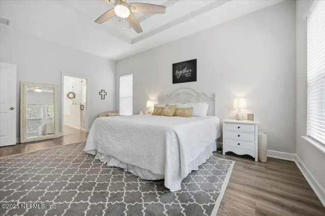 a spacious bedroom with a large bed and a chandelier
