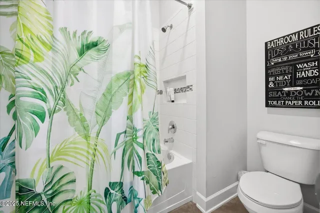a white vase with flowers on a table