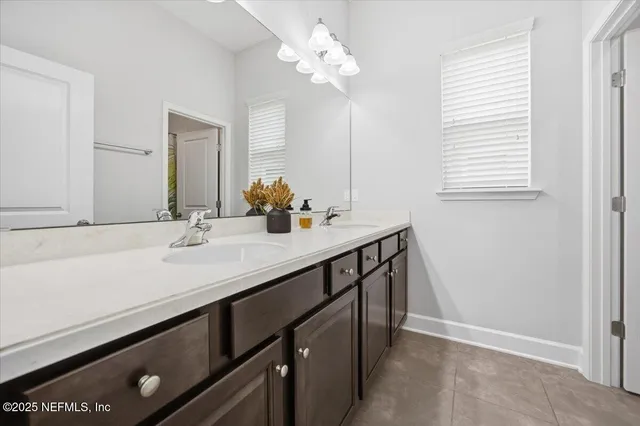 a bathroom with a sink a vanity and a mirror
