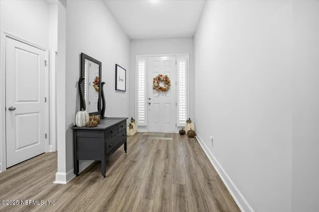 a view of hallway with wooden floor