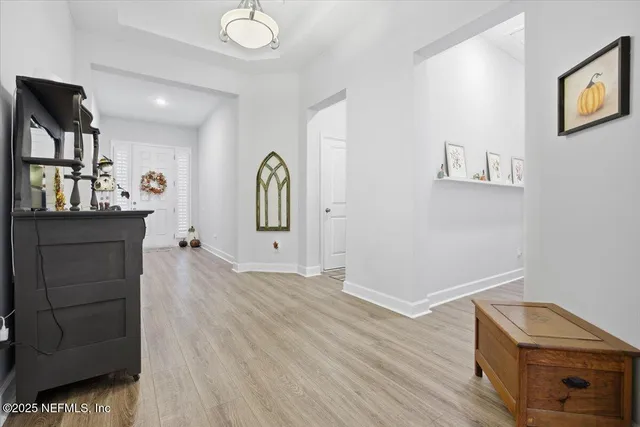 a view of a hallway with workspace and wooden floor