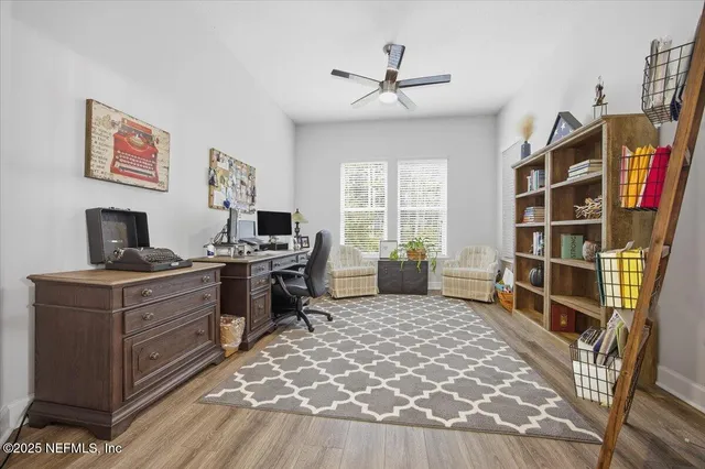 a view of a workspace with furniture and a window