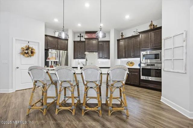 a large kitchen with a table and chairs