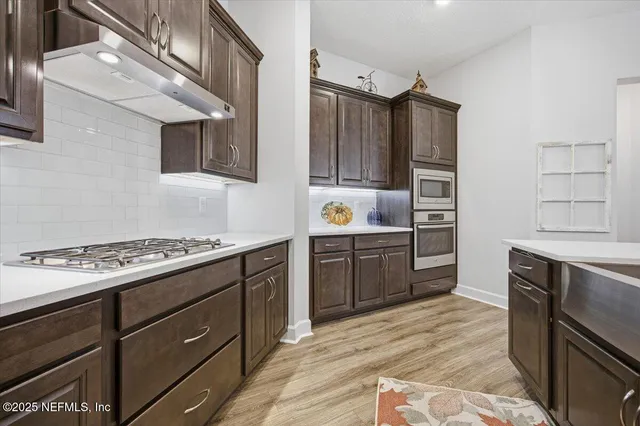 a kitchen with stainless steel appliances granite countertop a stove and a refrigerator