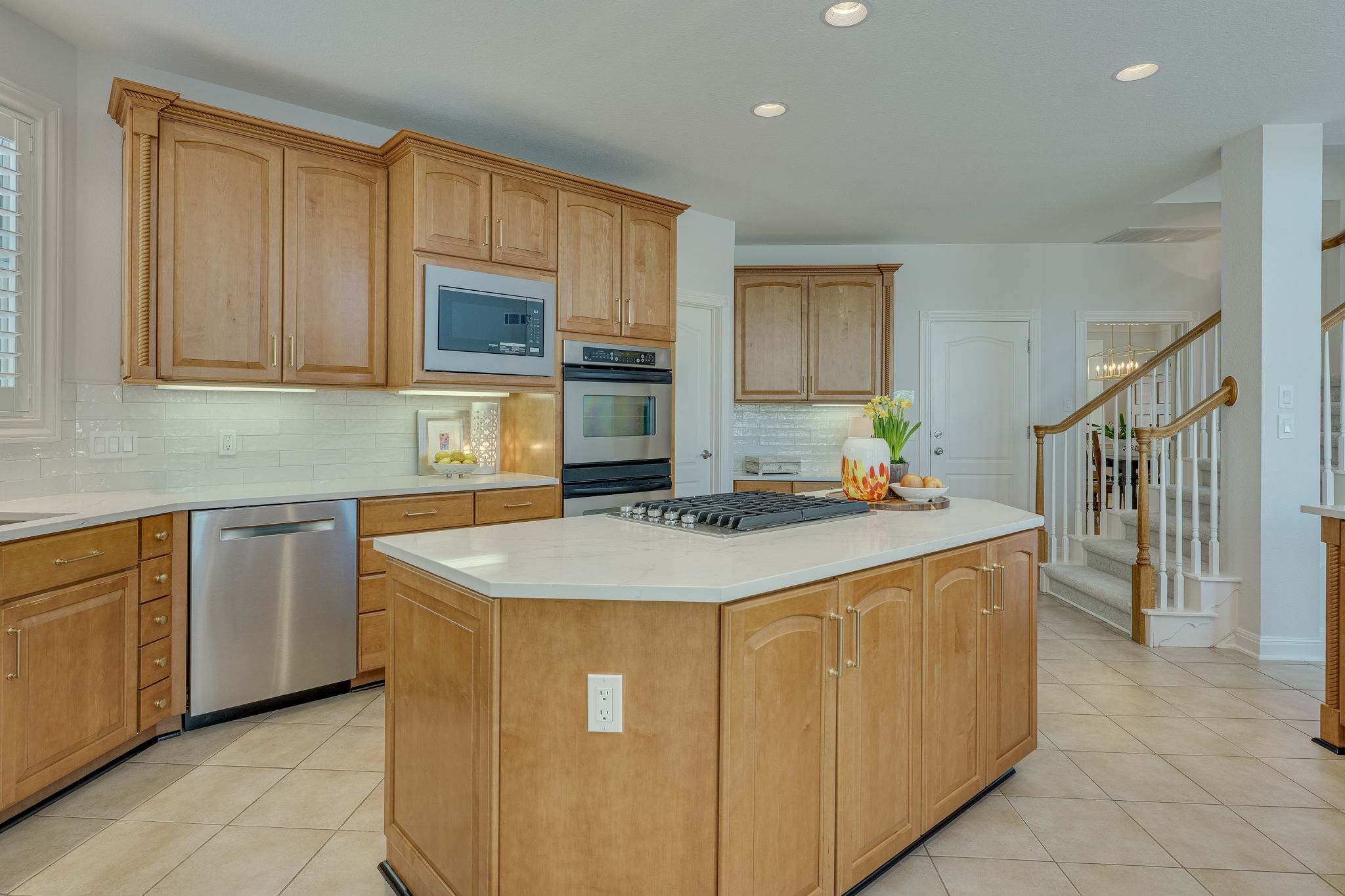 4424 Lago Viento Austin, TX 78734 - Photo 11 of 38 Enjoy cooking on the recently replaced 5 burner gas cooktop. The stairs located in the back of the kitchen are a set and there is easy access to the dining room. Located in the left back is the laundry room.