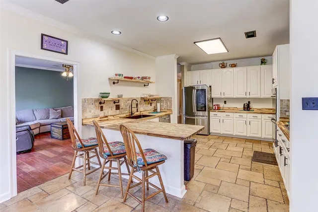 a kitchen with stainless steel appliances kitchen island granite countertop a sink and cabinets
