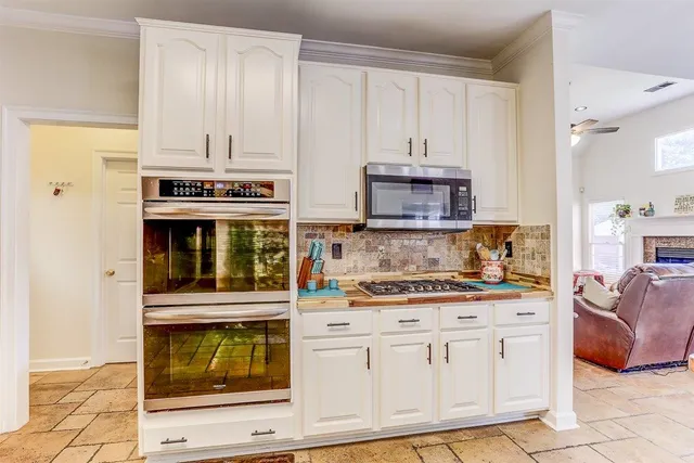 a kitchen with stainless steel appliances granite countertop a sink and cabinets