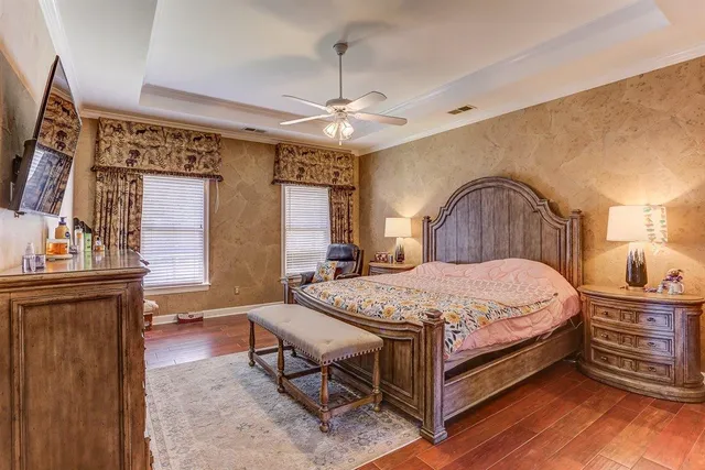 a bedroom with a bed and a chandelier