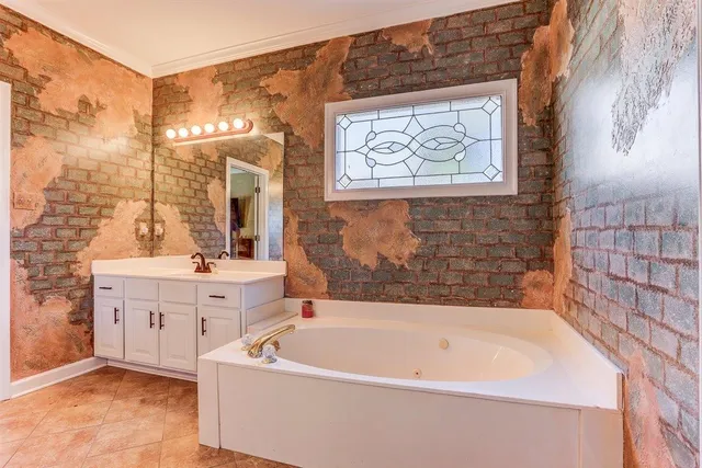 a bedroom with a bed table and dresser