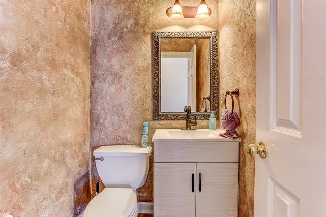 a bathroom with a bathtub a double vanity sink a vanity and a large mirror