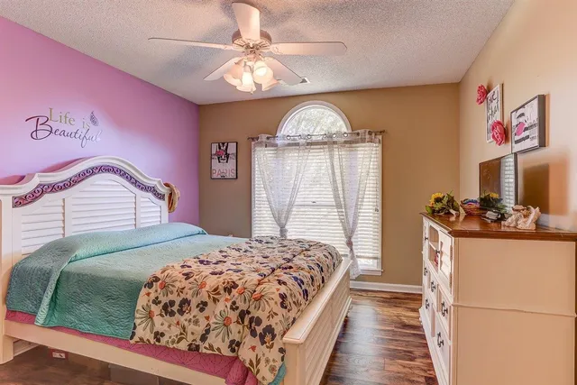 a bedroom with a large bed and a chandelier