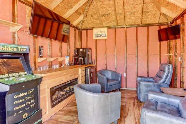 a view of a backyard with a patio and wooden fence