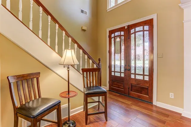 a view of entryway with wooden floor and stairs
