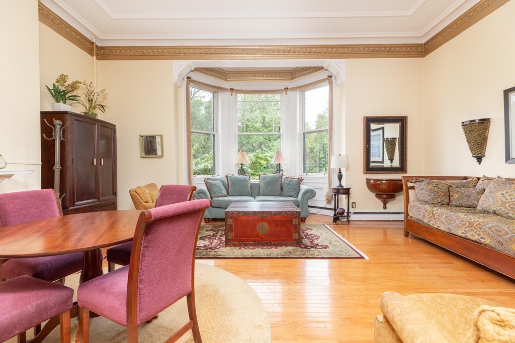 64 Commonwealth Avenue, Unit 3 Boston, MA 02116 - Photo 2 of 10 a living room with furniture and a large window