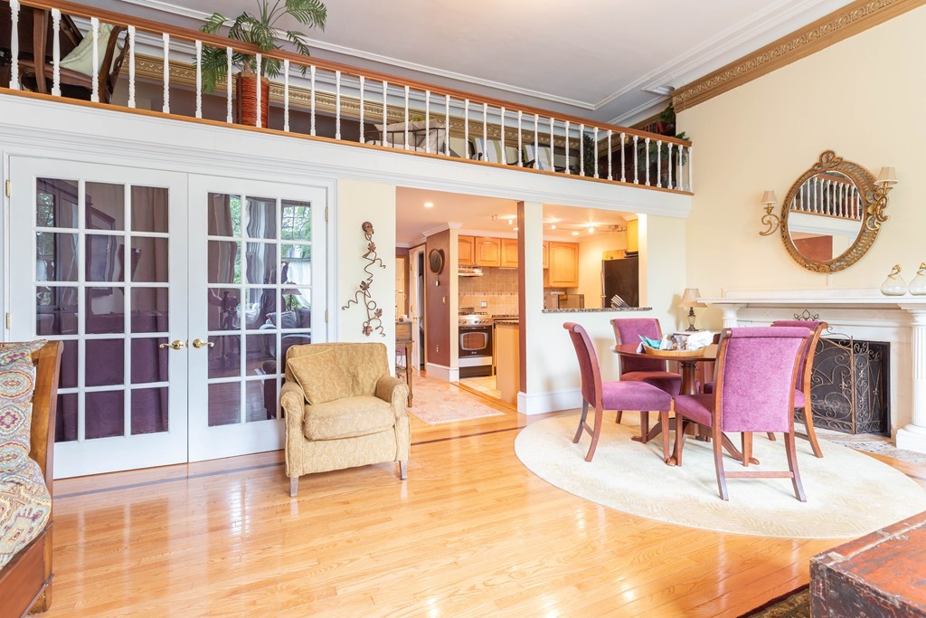 64 Commonwealth Avenue, Unit 3 Boston, MA 02116 - Photo 4 of 10 a view of a dining room with furniture a rug and wooden floor