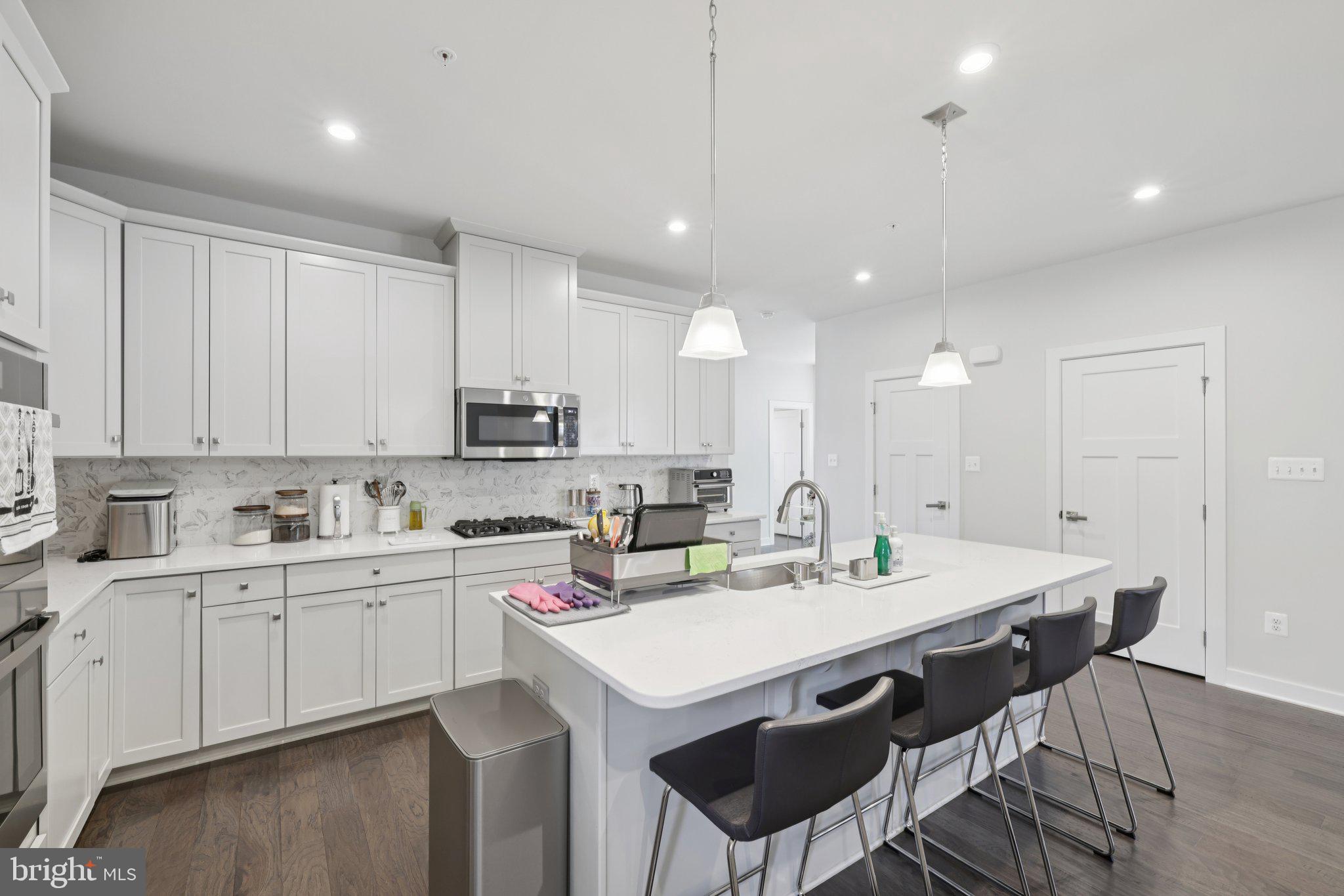 6604 River Birch Road Frederick, MD 21703 - Photo 19 of 58 a kitchen with a sink dining table and chairs