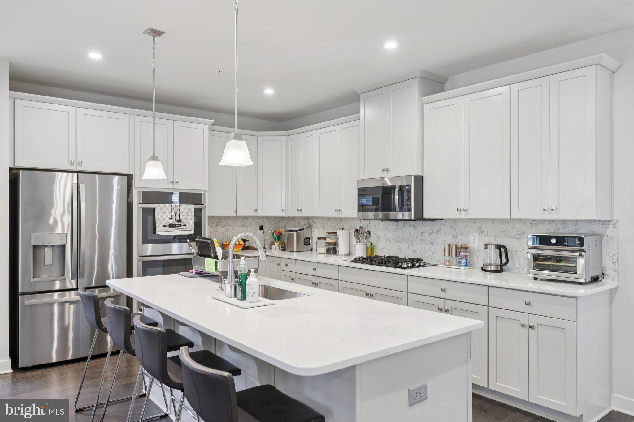 6604 River Birch Road Frederick, MD 21703 - Photo 21 of 58 a kitchen with stainless steel appliances a sink a stove a refrigerator and cabinets