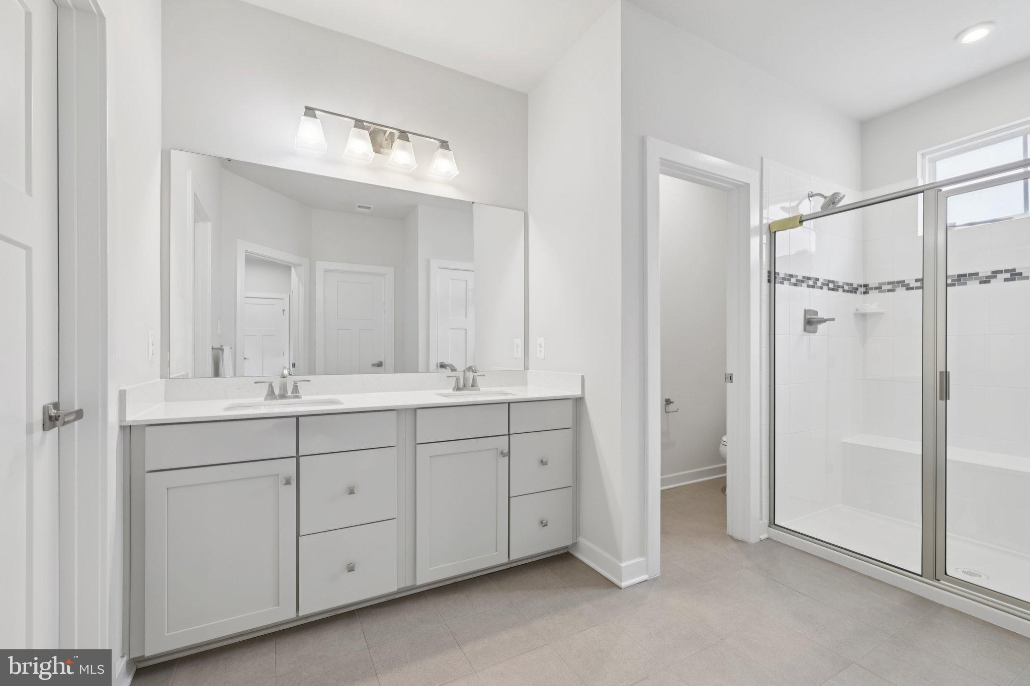 6604 River Birch Road Frederick, MD 21703 - Photo 29 of 58 a spacious bathroom with a double vanity sink mirror and