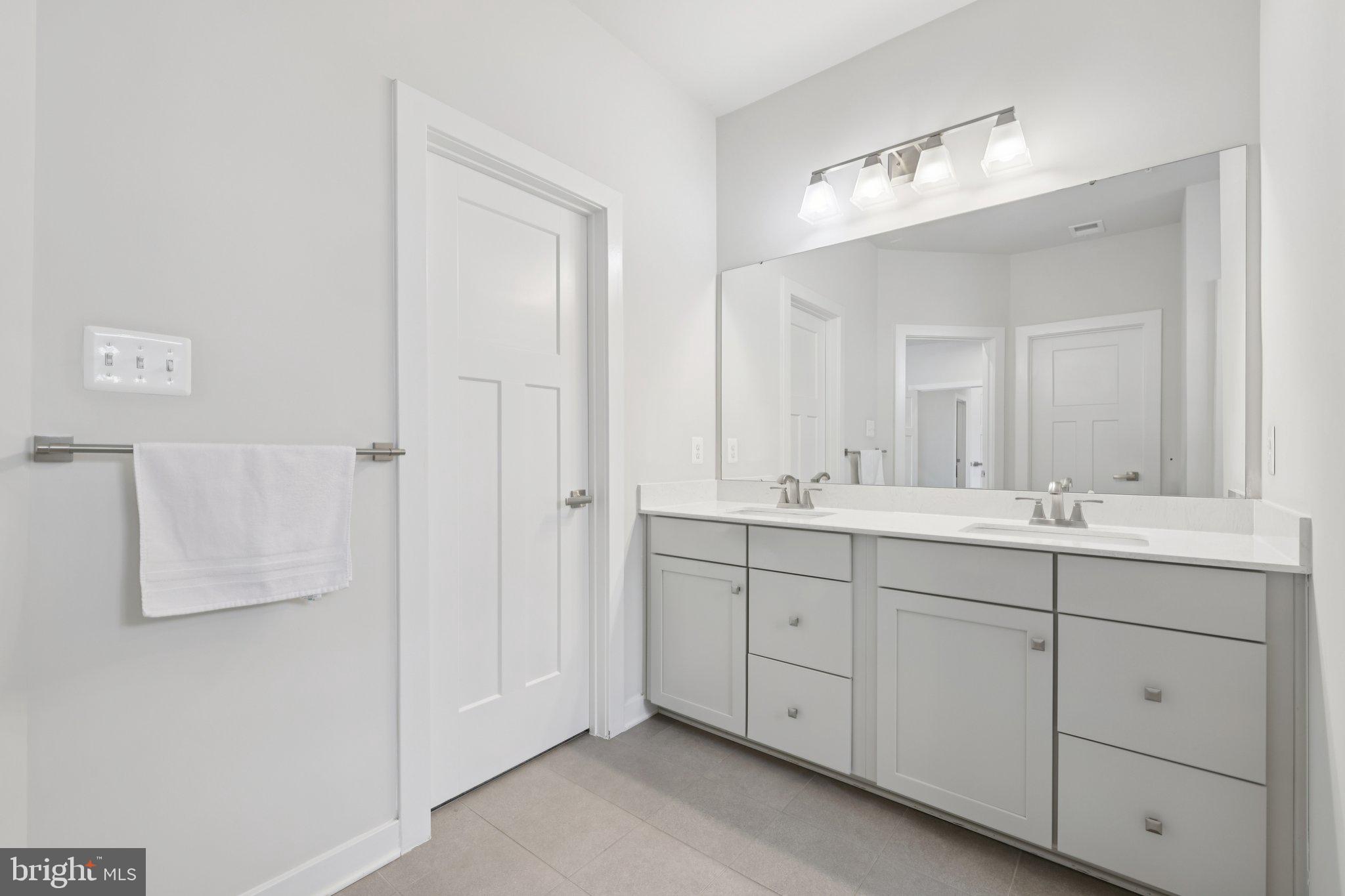 6604 River Birch Road Frederick, MD 21703 - Photo 30 of 58 a bathroom with a double vanity sink mirror and