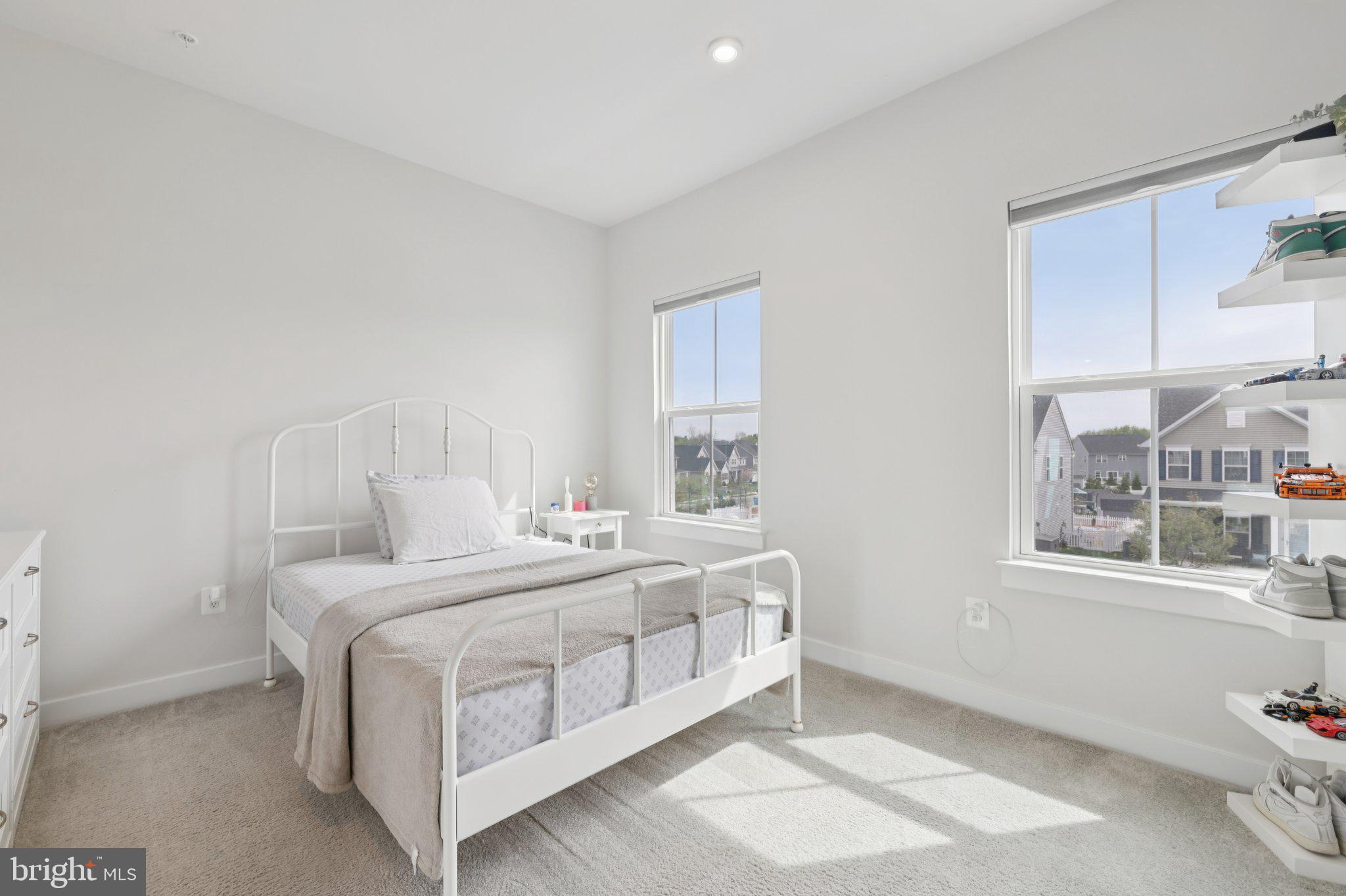 6604 River Birch Road Frederick, MD 21703 - Photo 33 of 58 a bedroom with a bed a table and windows