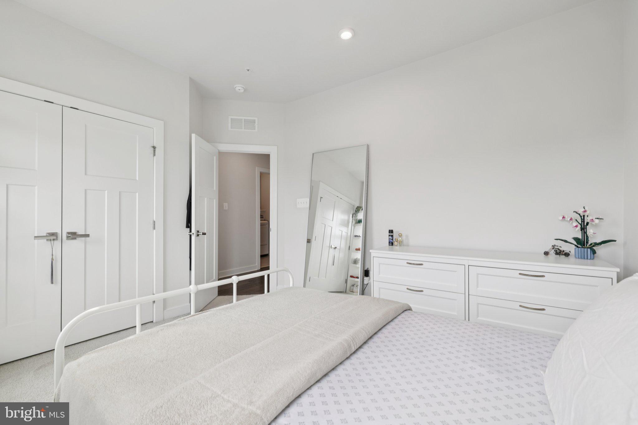 6604 River Birch Road Frederick, MD 21703 - Photo 34 of 58 a spacious bedroom with a bed and a large mirror