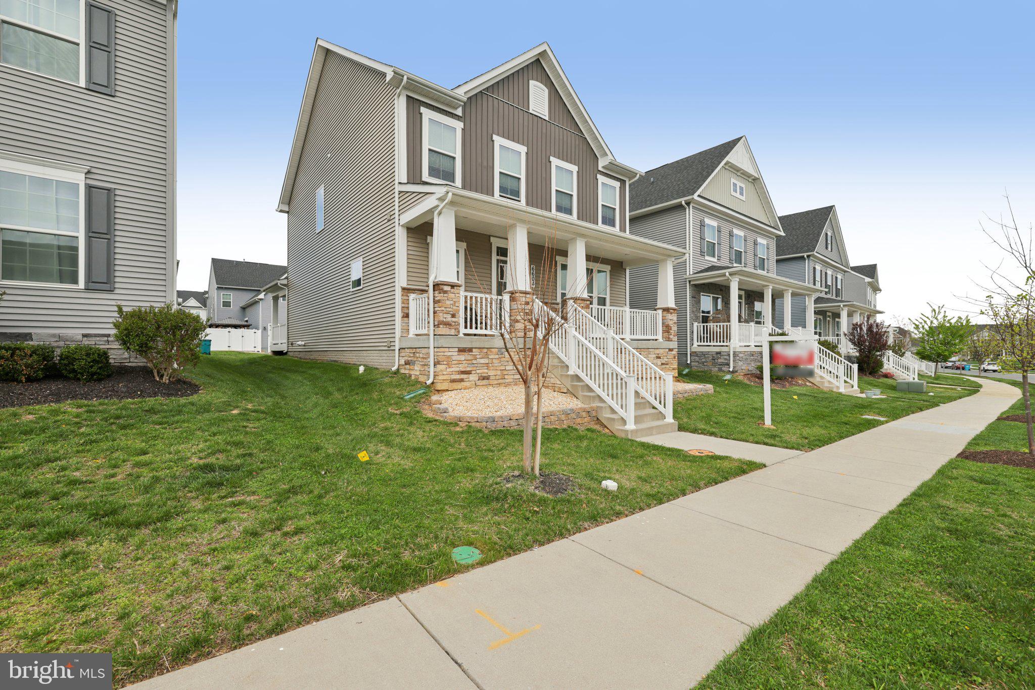6604 River Birch Road Frederick, MD 21703 - Photo 4 of 58 a front view of a house with garden