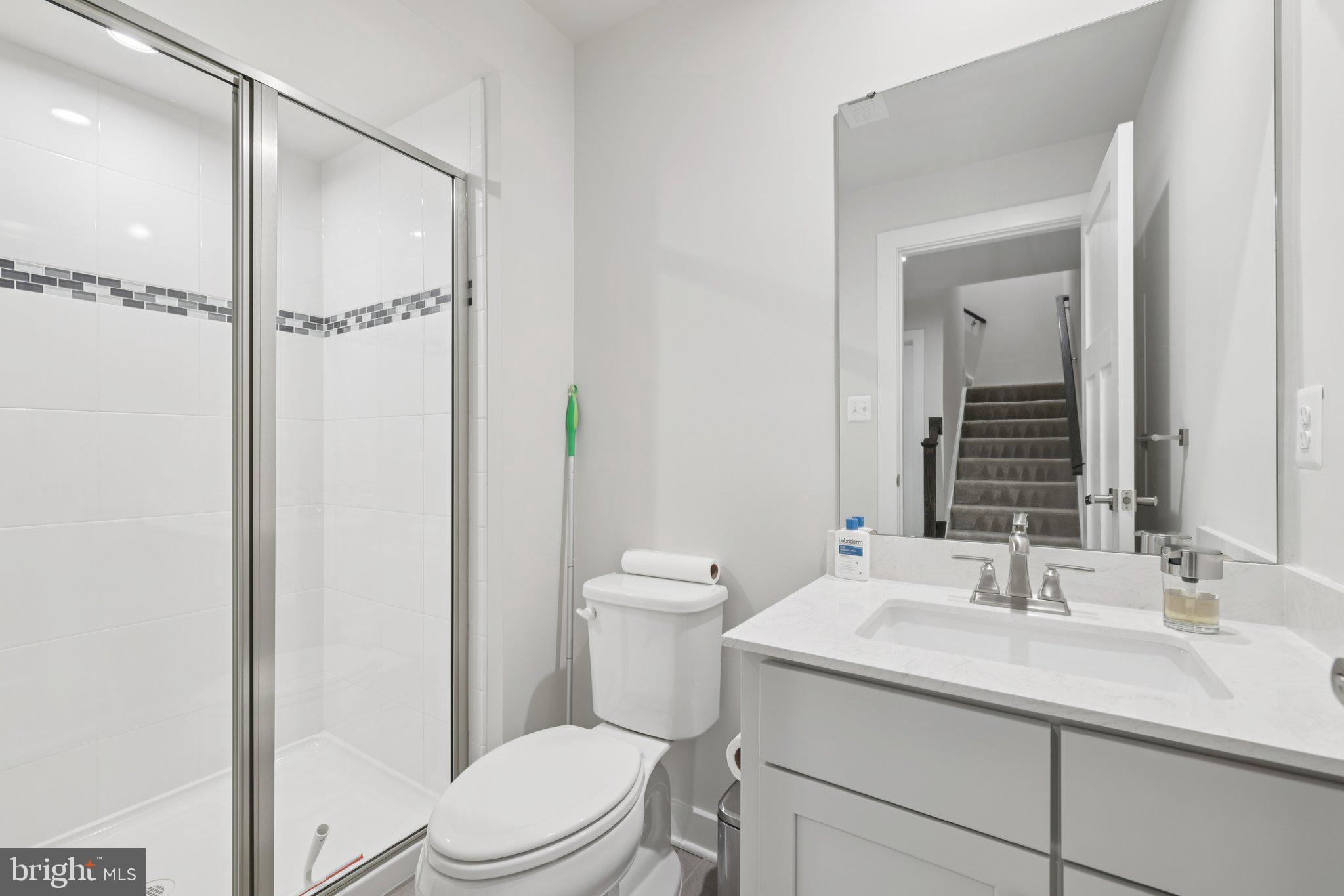 6604 River Birch Road Frederick, MD 21703 - Photo 50 of 58 a bathroom with a granite countertop sink toilet and shower