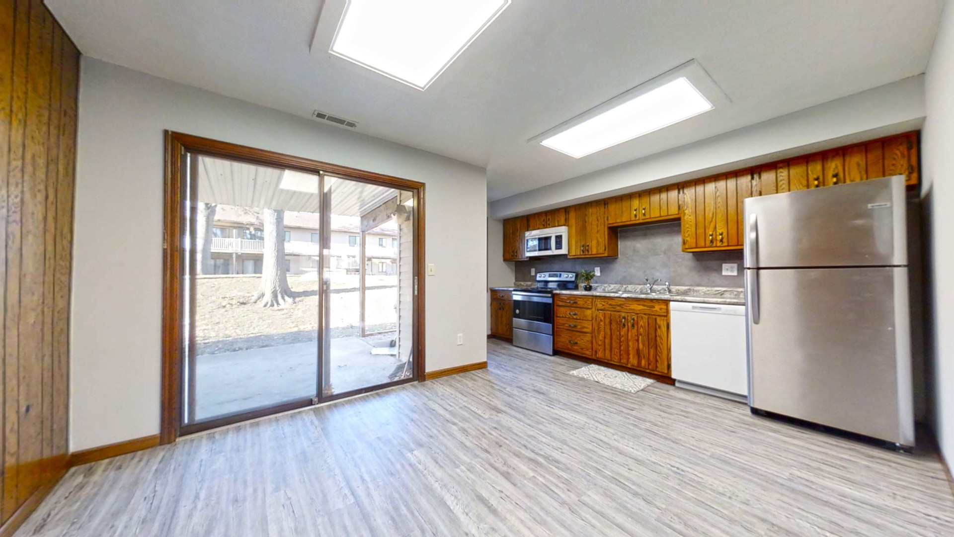1302 Christopher Circle, Unit 4 Urbana, IL 61802 - Photo 2 of 14 a kitchen with stainless steel appliances granite countertop a refrigerator a sink and a stove