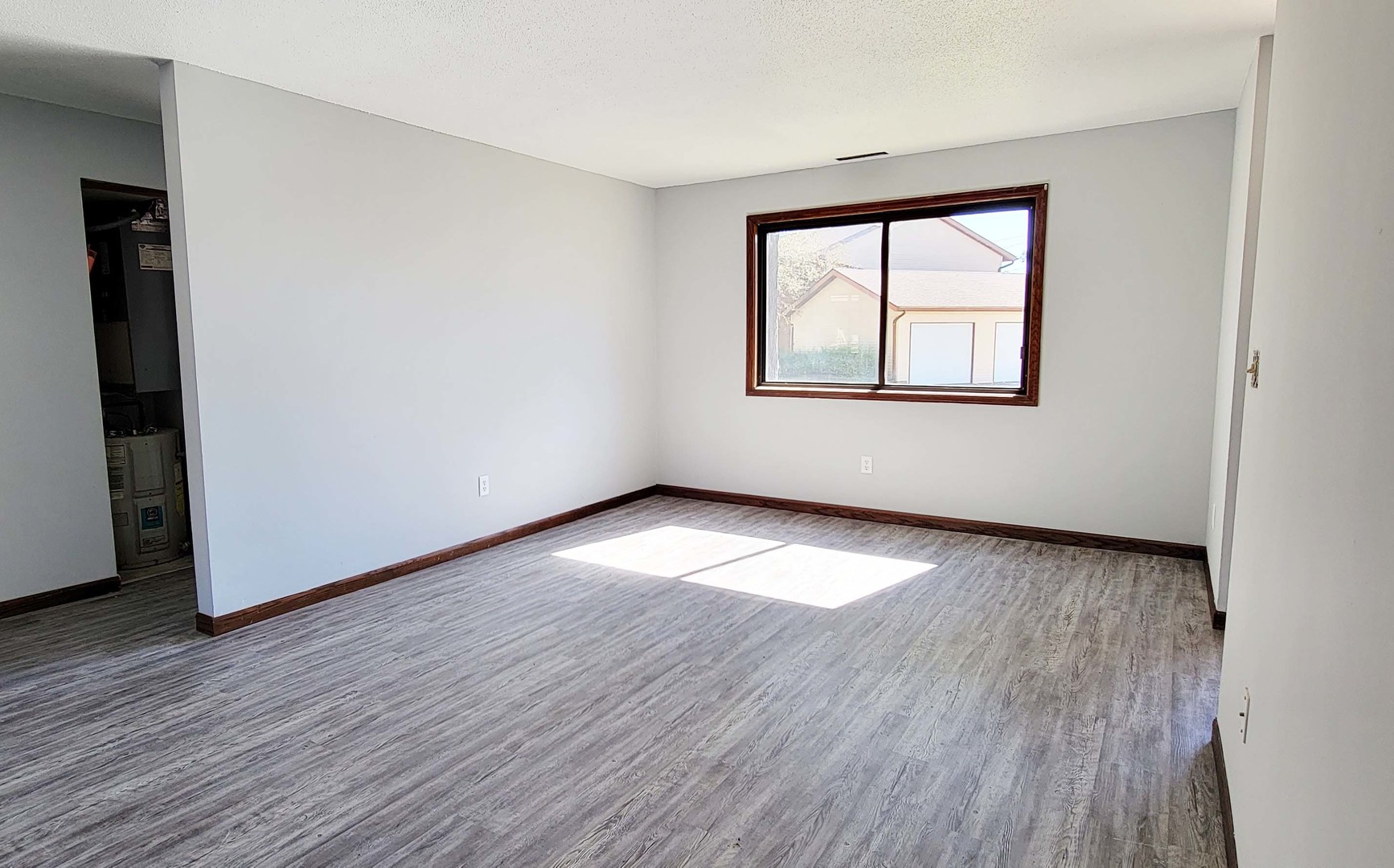 1302 Christopher Circle, Unit 4 Urbana, IL 61802 - Photo 11 of 14 an empty room with wooden floor and windows