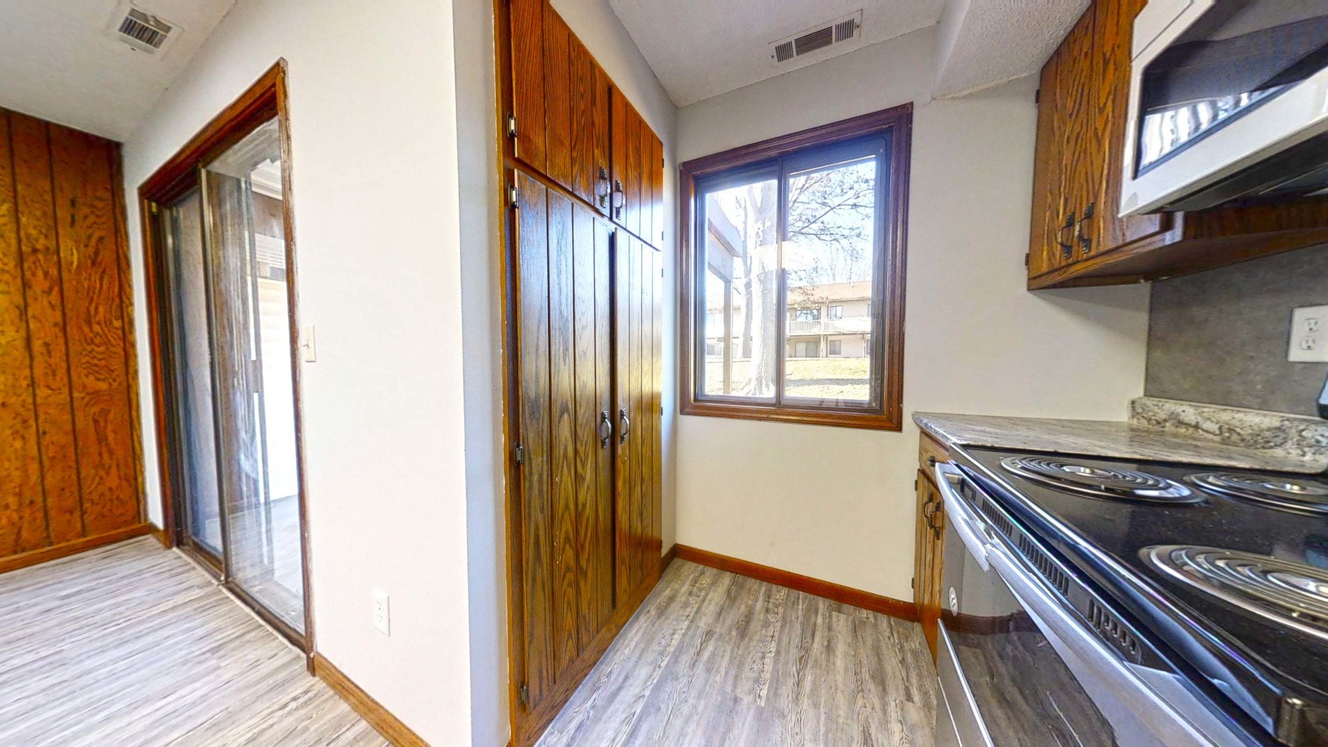 1302 Christopher Circle, Unit 4 Urbana, IL 61802 - Photo 3 of 14 a view of a hallway with wooden floor and cabinets